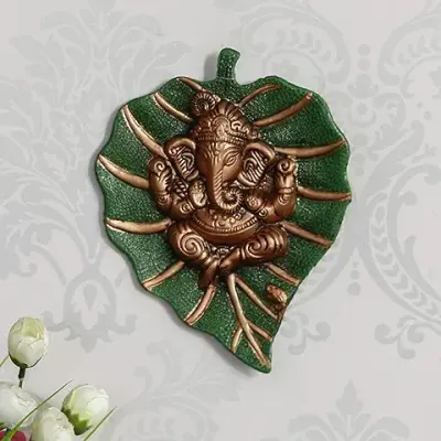 11. eCraftIndia Brown Beautiful Lord Ganesha on Green Leaf Metal Wall Hanging Sculpture Decorative Religious Showpiece for Home Wall Decor